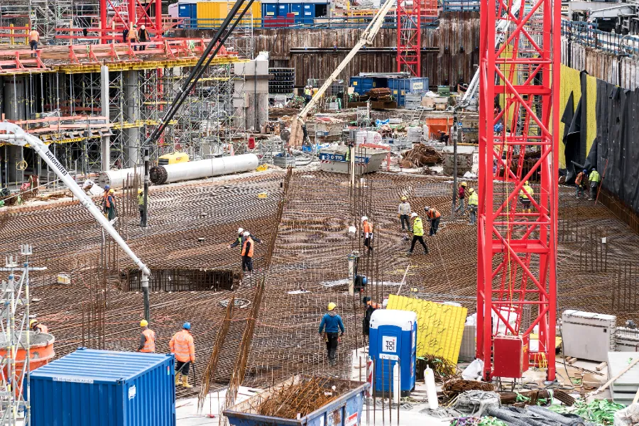 A busy building site with cranes and workers